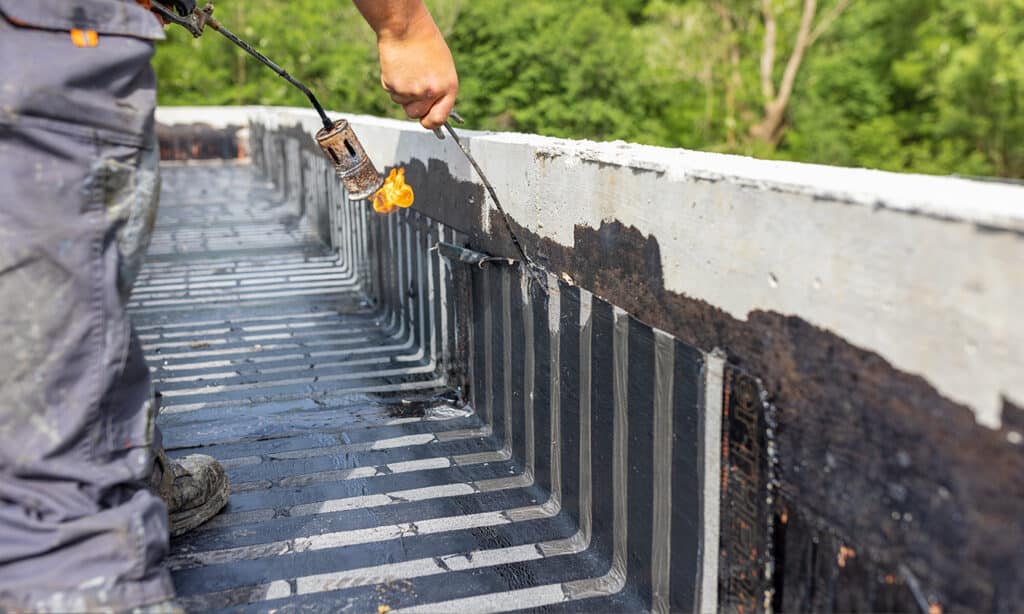 Step-by-step EPDM roof leak repair showing cleaning, applying primer, placing a patch, sealing with seam tape, and finishing with lap sealant for a watertight repair.