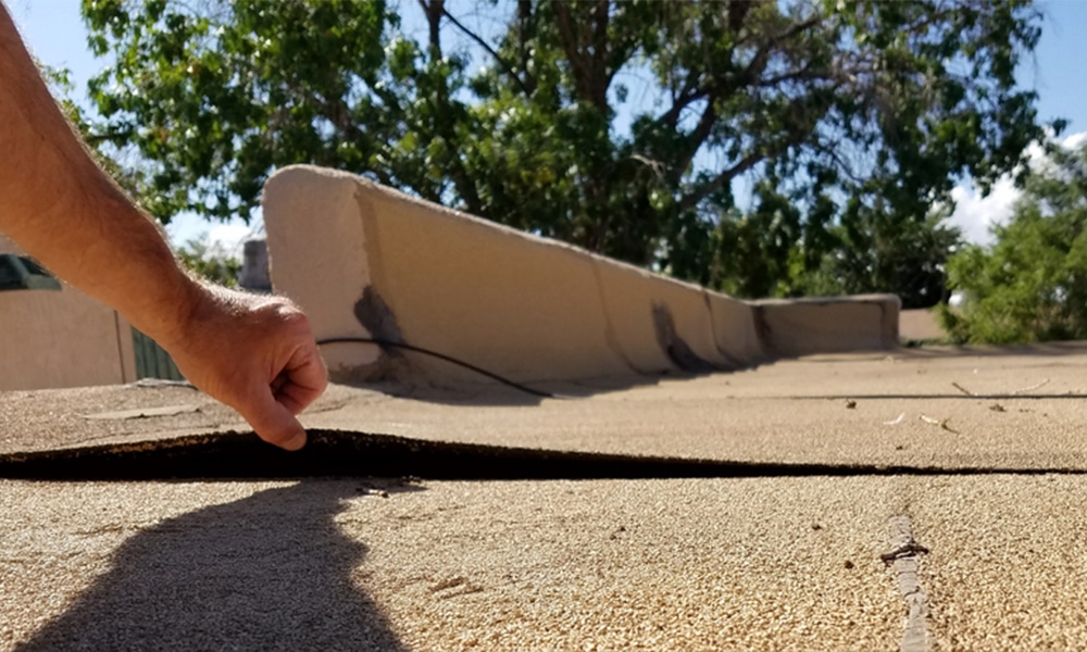 Roof inspection tips for detecting flat roof damage early, including signs like blistering, discoloration, and sagging areas