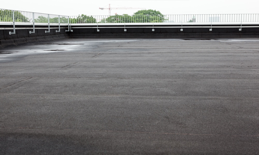 Flat roof problems including water pooling, cracks, and blisters that can lead to significant damage if not repaired