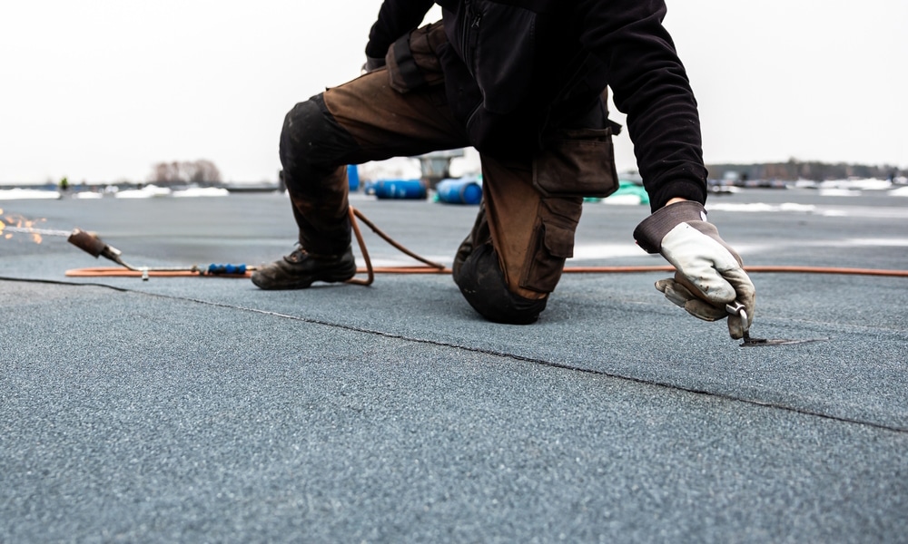 Flat roof repair showing a rooftop with a slight slope, designed to prevent water pooling and support features like gardens and solar panels