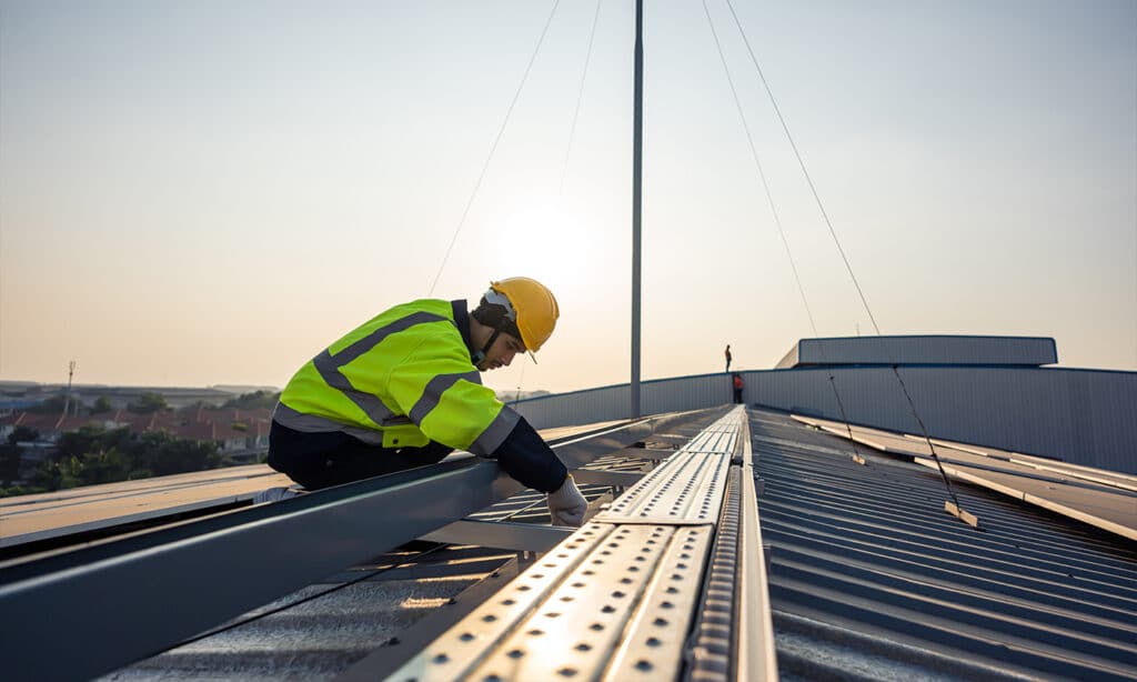 Step-by-step metal roof hole repair, including cleaning, patch application, edge sealing with sealant, and adding a protective coating for durability.