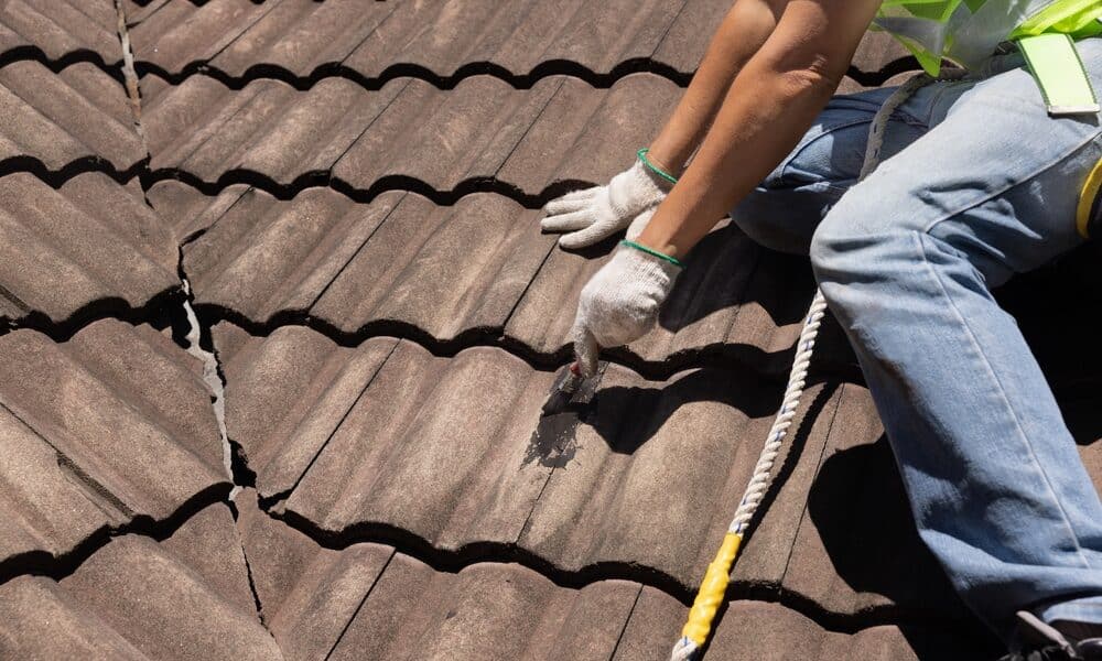 "Applying waterproof coating to a roof to prevent leaks and extend its lifespan."